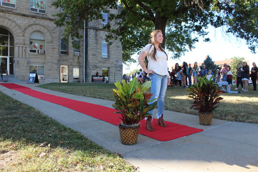 Faith Ford, a University of Central Missouri MBA student, shows off an outfit from Crave Boutique during a fashion show hosted by UCM Fashion &amp; Merchandising students at the Moonlight Market on Saturday, Sept. 25, 2021.