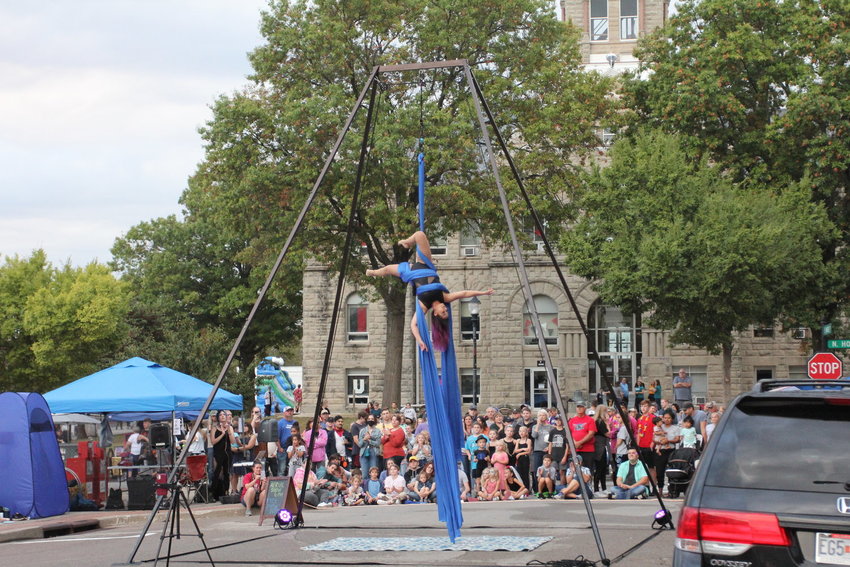 An artist uses aerial silks in a performance during Burg Fest in 2021 in downtown Warrensburg.