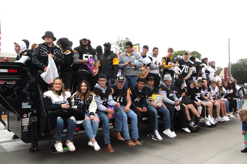 The Smith-Cotton High School football team sits on a trailer throwing candy as they go through the Homecoming parade route through downtown Sedalia in 2021.