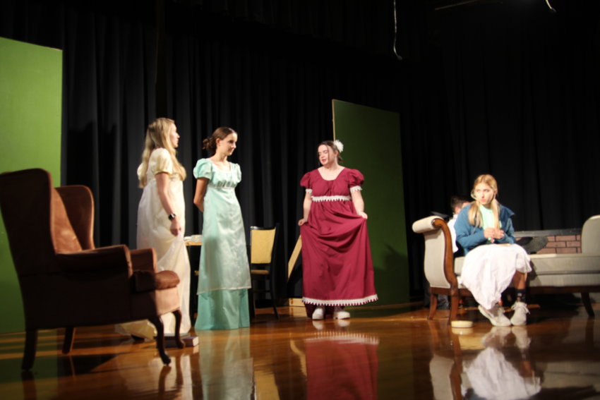 While in the sitting room of the Bennet house, Lydia Bennet (Kristen Smith), Catherine &lsquo;Kitty&rsquo; Bennet (Murray Page), Mrs. Bennet (Izzy Brown) and Jane Bennet (Josie Bray) discuss the new suitors who have come to town during Monday night&rsquo;s rehearsal of &ldquo;Pride and Prejudice&rdquo; at Smithton High School. The production will be performed Friday and Saturday.