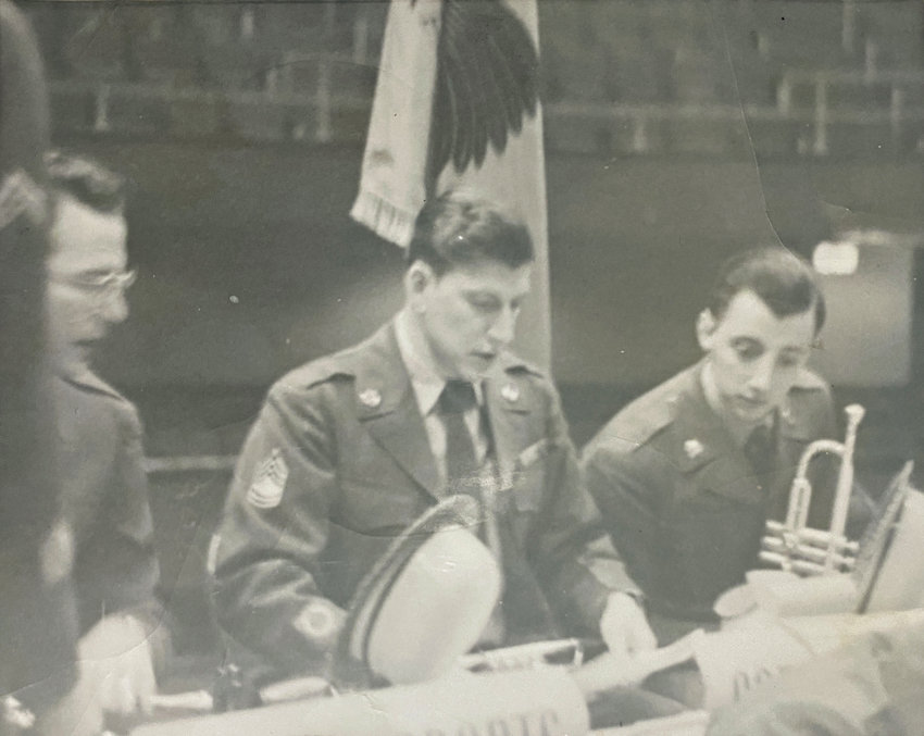 Louis Cooke, far right, holding his trumpet, is seen with his sergeant and another soldier before they perform with the 371st Army Band in the 1950s at Fort Leavenworth, Kansas.