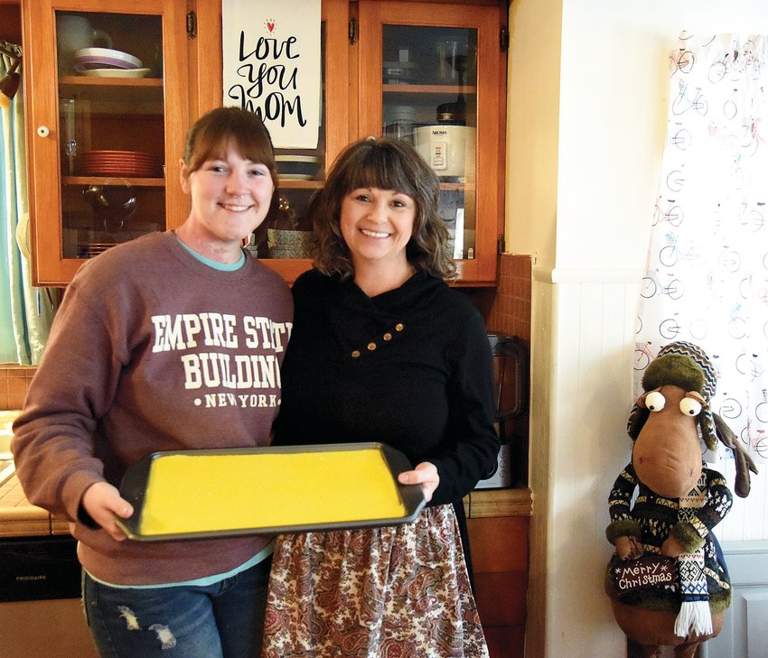 Meredith Hickman, left, and her mother, Wilma Moellman, both of Sedalia, hold a batch of homemade lemon fudge on Thursday. The women own Fudge Fairies and use a recipe by Moellman&rsquo;s late mother, Goldie Shown.