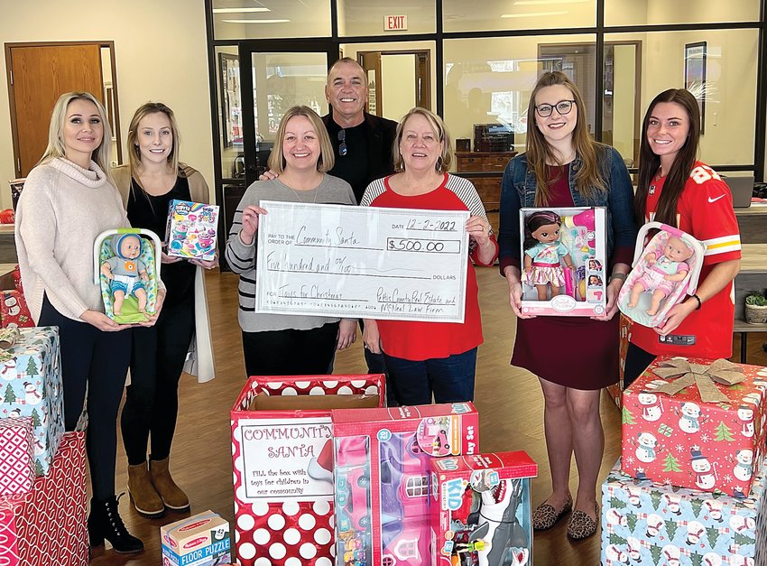 Pettis County Real Estate Company and McNeal Law Firm donated a box full of new toys and a $500 check to Pettis County Community Santa. Pictured from left are Nadia Fray, Sadie Reeser, Kelly Miller, Myron McNeal, Carol McMullen (Community Santa volunteer), Allison Kroeger and MacKenley Scotten.