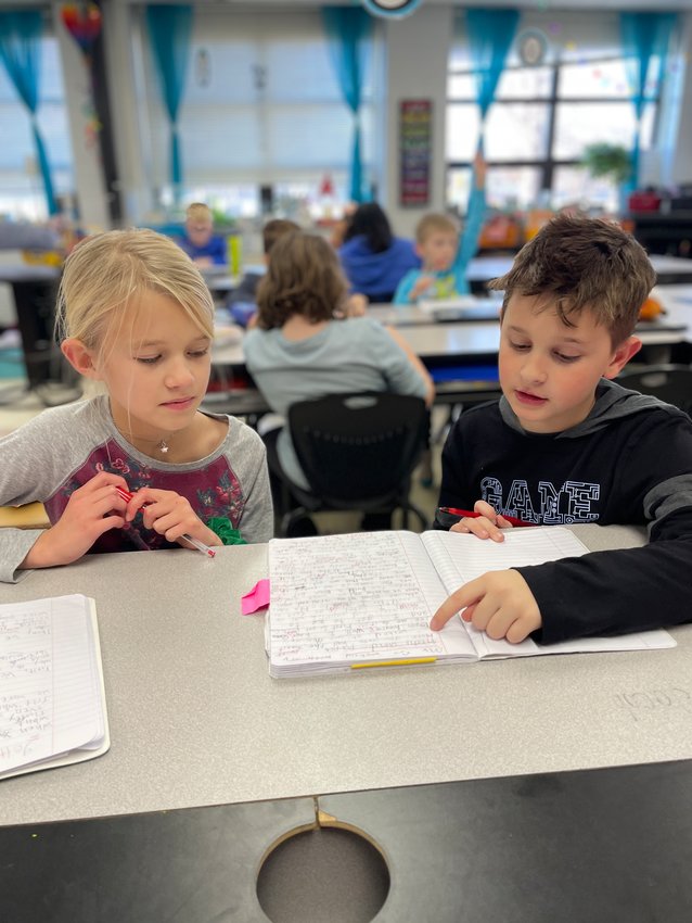 Susie Howe&rsquo;s English language arts third grade students Cora Singer and Jacob Bennett work together to peer edit and revise their &ldquo;Small Moments&rdquo; stories.