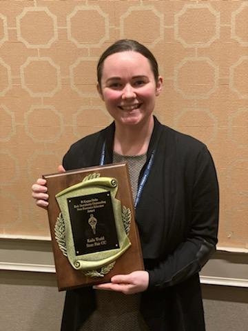 State Fair Community College Communication Instructor Kaila Todd holds the Dr. Bob Derryberry Award at the National Communication Association conference.