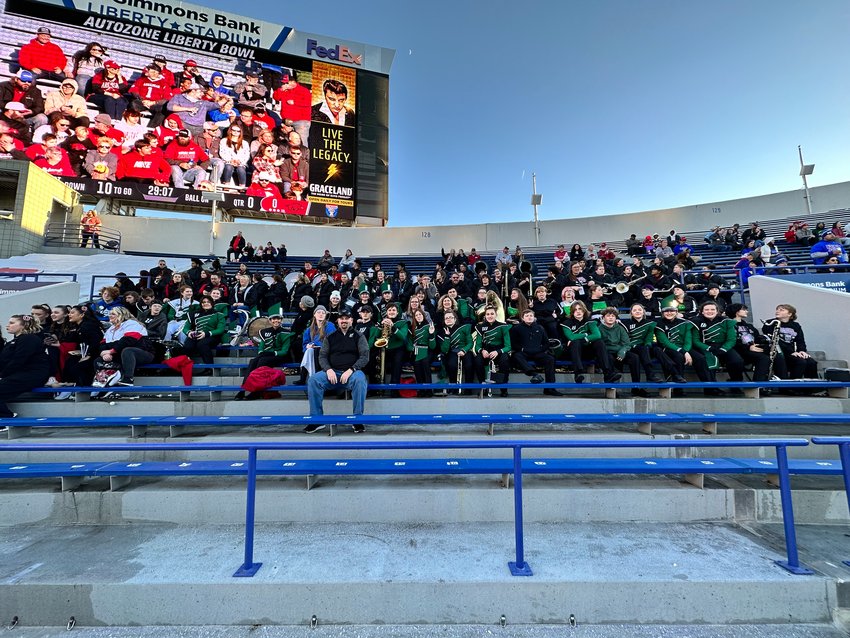 The Warsaw Wildcat Band sits together with parents and supporters to get a group photo at the Liberty Bowl on Dec. 28. The band traveled all the way to Memphis, Tennessee, to participate in the halftime show.