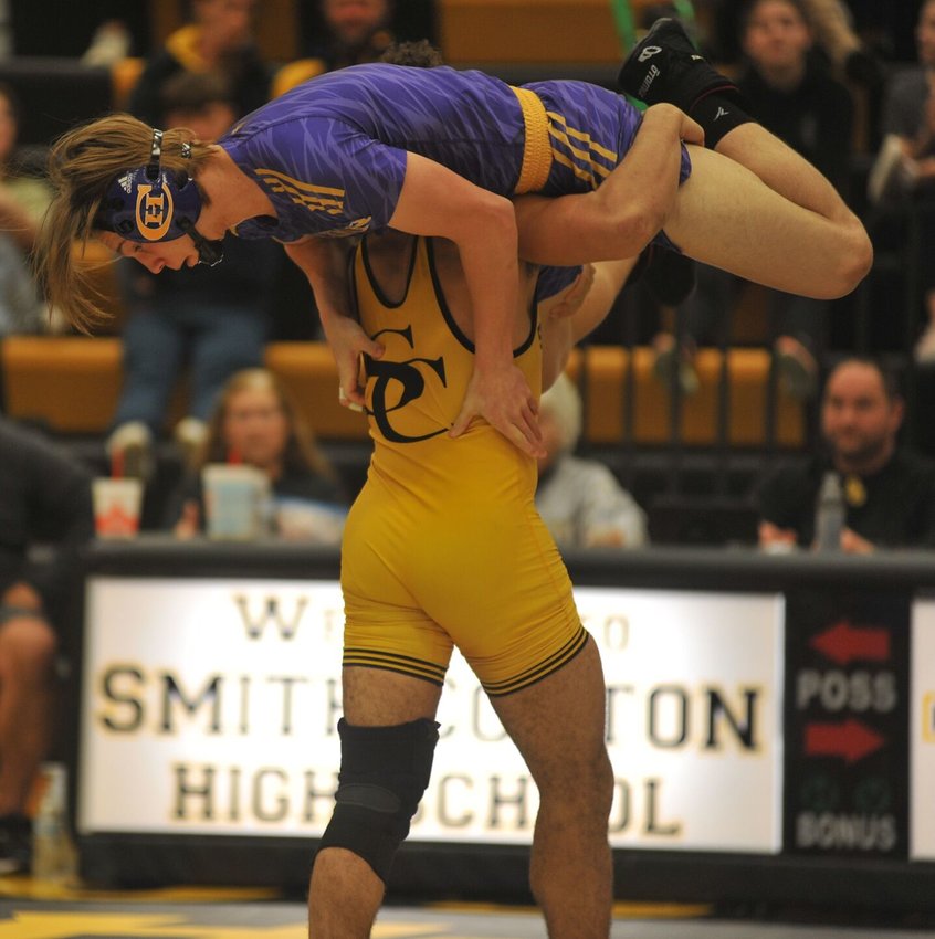 Smith-Cotton senior Josiah Oliver takes his Kewpies opponent for a lift in a win at home Tuesday night.   PhotoCredit: Photos by Bryan Everson | Democrat