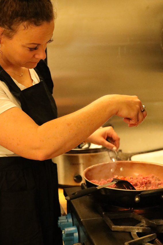 Ahfton Rupe,&nbsp;Owner of The Well Balanced Table,&nbsp;browns some beef while she prepares a meal for a customer.   Photo courtesy of Ahfton Rupe&nbsp;