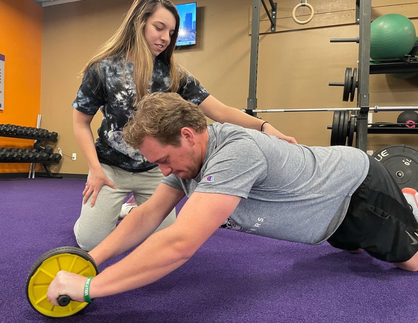 Anytime Fitness Manager Vanessa Grosso coaches Jackson Kempton on proper form. Kempton has lost 43 pounds in the past year and now loves going to the gym.&nbsp;