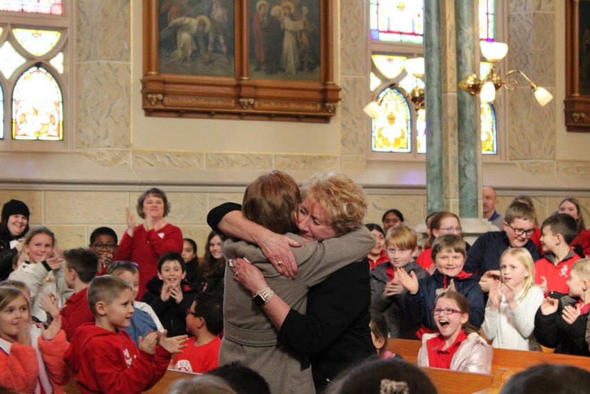 Robin Williams receives a hug from an all school mass attendee after it was announced that she received Teacher of the Year on Feb. 3. During the hug, onlookers could see Williams almost in tears.&nbsp;