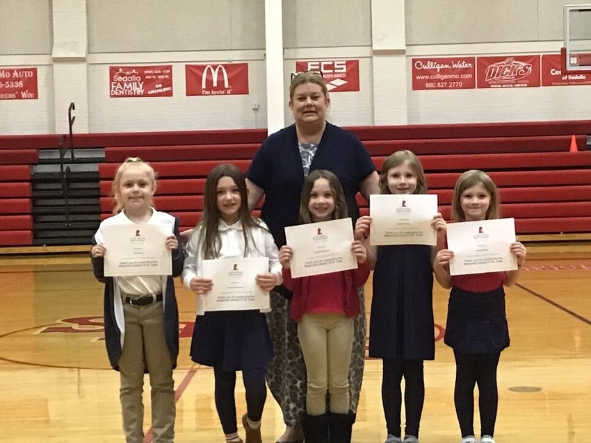 Pictured with the faculty coordinator are the five top earners. Front row from left, Finlee Hout ($1,662), Brooklyn and Londyn Dickinson ($1,200), and Braelynn and Everly Bloess ($565). Back row, Sacred Heart Principal Nancy Manning.