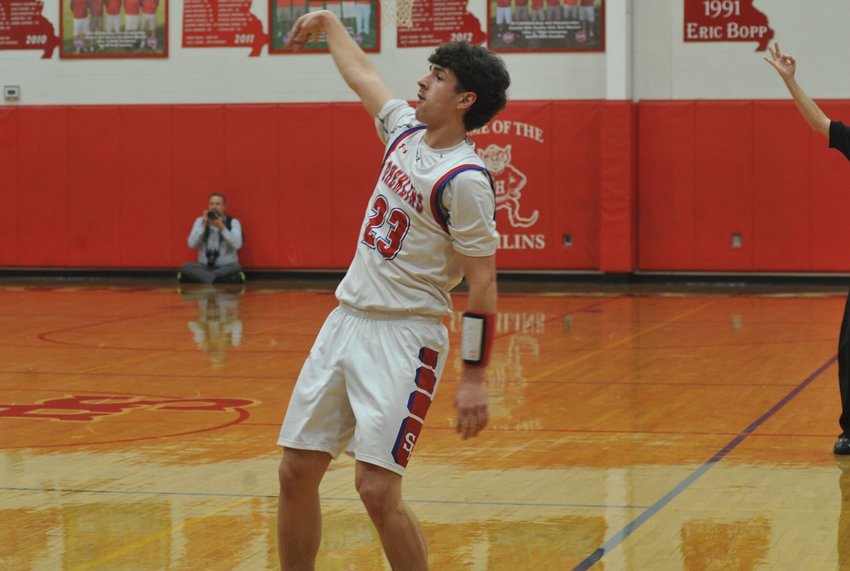 Sacred Heart junior Carter Rice watches his three-point attempt in Friday night&rsquo;s home contest against Otterville.   PhotoCredit: Photo by Bryan Everson | Democrat