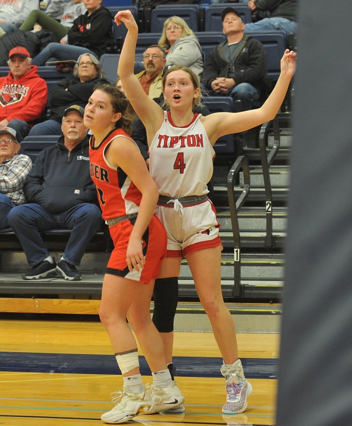 Tipton senior Myra Claas shoots a corner 3-pointer while being guarded by Stover junior Hannah Bauer in a Kaysinger Conference Girls Tournament semifinal Monday night.   PhotoCredit: Photo by Bryan Everson | Democrat