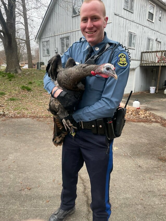 Missouri State Trooper Micah Bennett is seen Tuesday after arresting Gus, a wild turkey that had been menacing people in the 32nd Street and South Ohio Avenue neighborhood.   Photo courtesy of Missouri State Highway Patrol Troop A