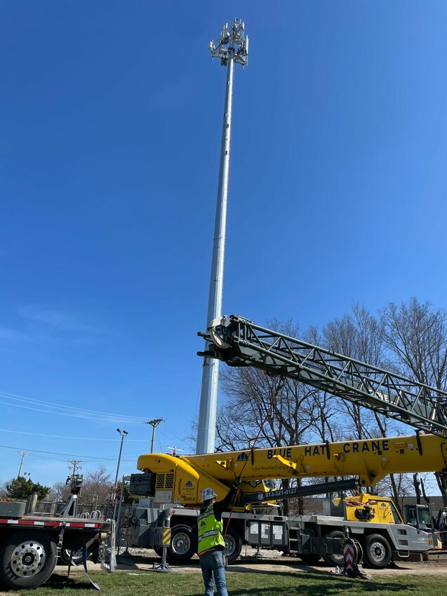 Blue Hat Crane, out of metro Kansas City, installs a cell phone tower on the southwest corner of U.S. Highway 65 and U.S. Highway 50 on Wednesday afternoon. Adam Pollard was the operator of the 150-foot crane.   Photo by Chris Howell | Democrat