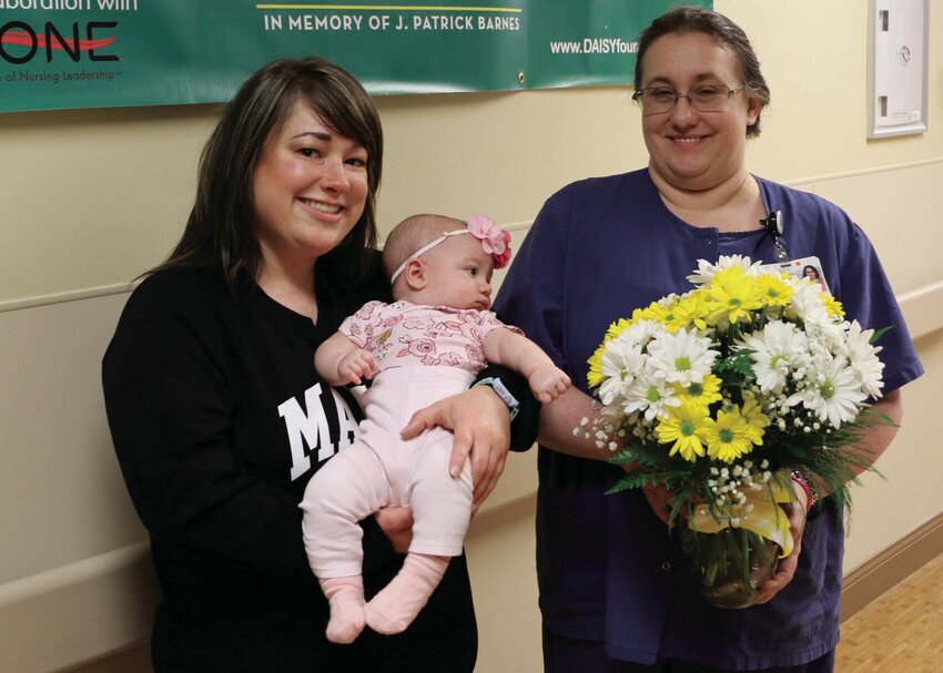 From left, Brittany Rieves, holding her daughter Ashlyn, and Stacey Nassar, Bothwell Women&rsquo;s Health and Newborn Care RN. Rieves nominated Nassar for the DAISY Award for taking special care of her when Ashlyn had to be transferred to MU Health after her birth last November.   Photo by Bothwell Regional Health Center