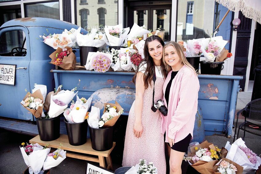 During the Ukrainian Festival in April 2022, sisters Victoria and Milana Kondratyuk, of the Sedalia Tabernacle Church, sold flower bouquets to visitors. The second annual Ukrainian Festival will be hosted from 11 a.m. to 5 p.m. Saturday, April 29 in downtown Sedalia. All proceeds from the event will go toward Ukrainian humanitarian aid.   File photo by Faith Bemiss | Democrat