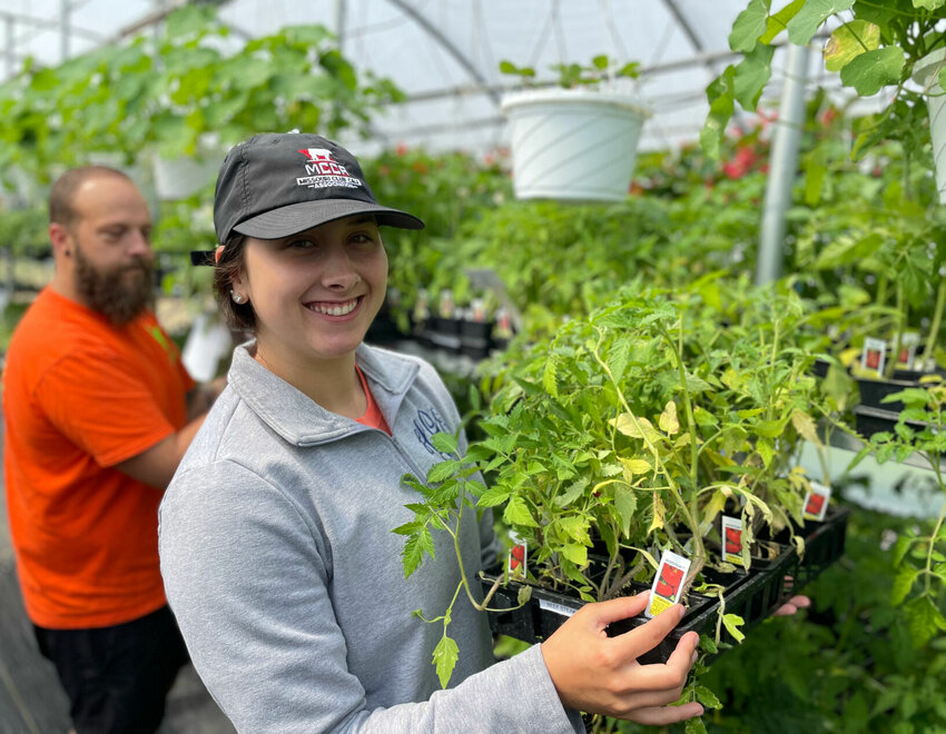State Fair Community College horticulture students Josh Wickwar and Hallie Giesike, seen Friday, April 28, and many others have spent countless hours raising, watering, transplanting and preparing the plants for the annual plant sale.   Photo by Chris Howell | Democrat