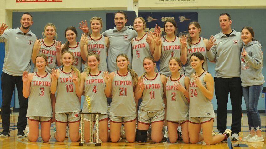 Tipton players hold up four fingers signifying the Lady Cardinals' run of consecutive Kaysinger Conference Girls Tournament Championships after winning their latest Friday night in Sedalia.   PhotoCredit: Photo by Bryan Everson | Democrat