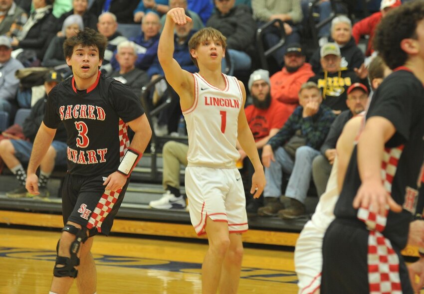 Lincoln's Kaleb Mundy watches his attempted 3-pointer in Tuesday night's Kaysinger Conference Boys Tournament semifinal victory over Sacred Heart. His team will meet another side of Cardinals, Tipton, in Saturday's title game.   PhotoCredit: Photo by Bryan Everson | Democrat