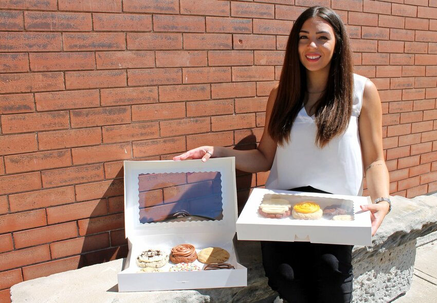 Kaytlen Flores, of Knob Noster, shows off a variety of cookie flavors available through her in-home bakery, Cookie Cravings, on Wednesday, May 3. The online business opened about a year ago.   Photo by Nicole Cooke | Warrensburg Star-Journal