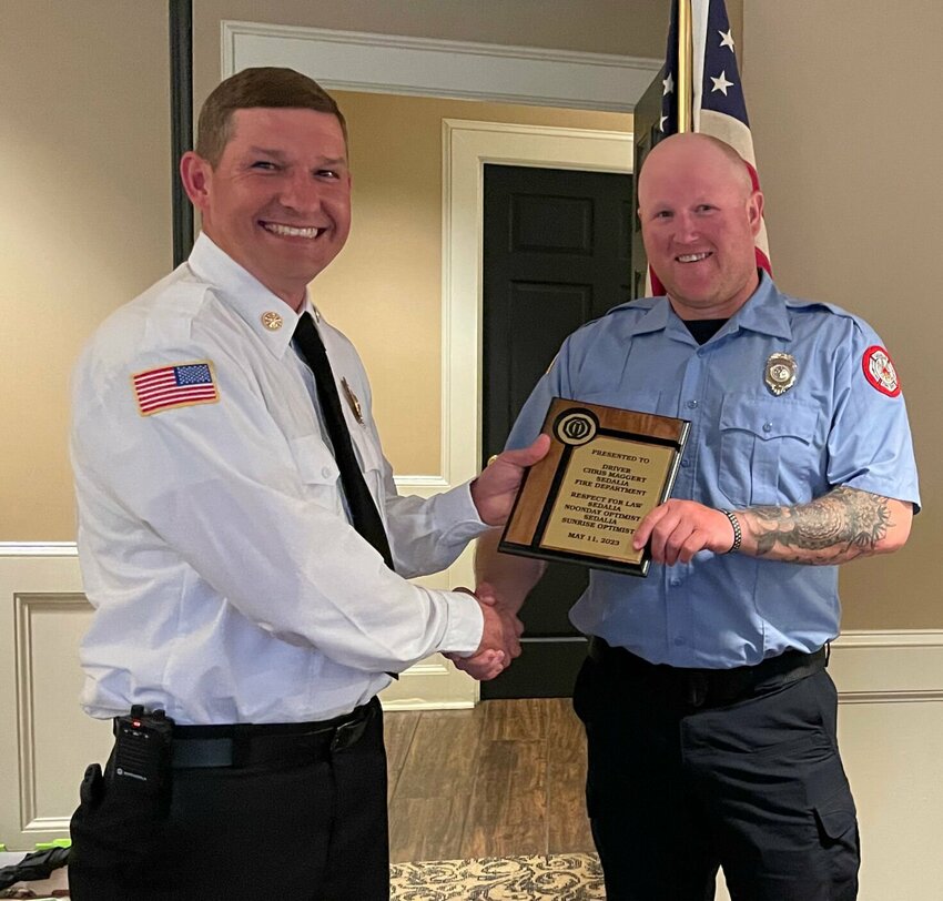 Sedalia Fire Chief Matt Irwin presents driver Christopher Maggert an award at the Noonday Optimist Club's Respect for Law Banquet hosted Thursday evening, May 11 at the Sedalia Country Club.   Photo by Chris Howell | Democrat