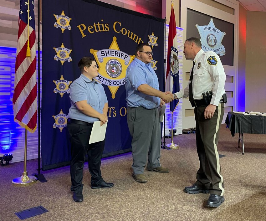 Corrections officers Cheyenne Kessing and Michael Laster are congratulated by Sheriff Brad Anders at the Sheriff's Awards Thursday, May 11 at Cornerstone Baptist Church. Kessing and Laster saved an inmate who was attempting to hang himself in December.   Photo by Chris Howell | Democrat