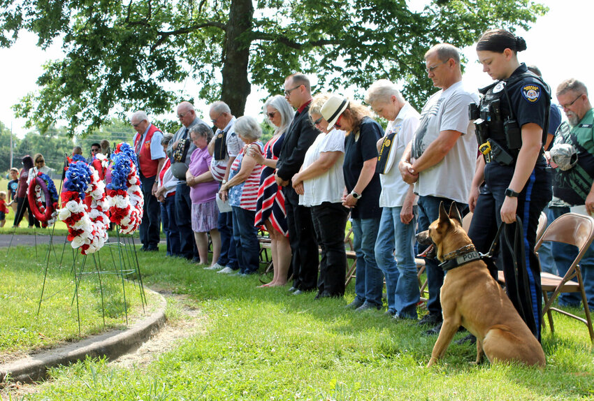 With memorial wreaths in front of them, members of Sedalia veterans organizations, local and state officials, and community members bow their heads as Jim Gaertner, of Voiture 333 40&amp;amp;8, not pictured, gives the benediction at the conclusion of the Memorial Day ceremony hosted Monday morning, May 29 at Crown Hill Cemetery. The annual event was hosted by American Legion Post 491, VFW Post 2591, and 40&amp;amp;8.   Photo by Nicole Cooke | Democrat