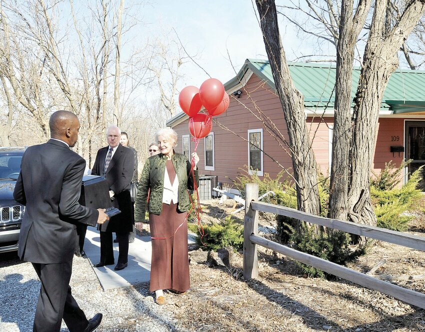 In January 2017, Mark Nolen carries his mother, Rose Nolen&rsquo;s, ashes past her former home and now the Rose M. Nolen Black History Library. The library was established by Marge Harlan, on the right, who is currently ill. Mark Nolen is in Sedalia, hoping to receive community support to save the library and his mother&rsquo;s memory.   File photo by Faith Bemiss | Democrat