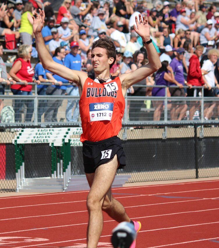 Stover senior Blaine Brodersen throws his hands in the air in celebration as he crosses the line as winner of Saturday's Class 2 3,200-meter run.   PhotoCredit: Photo by Bryan Everson | Democrat