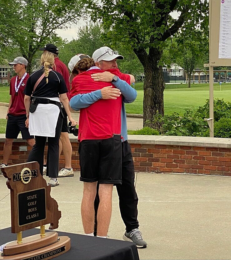Sacred Heart junior Luke Jenkins gets a hug from his dad, Bryan, after finishing second at the Class 1 State Tournament, held in Columbia.   PhotoCredit: Photo courtesy of Luke Jenkins
