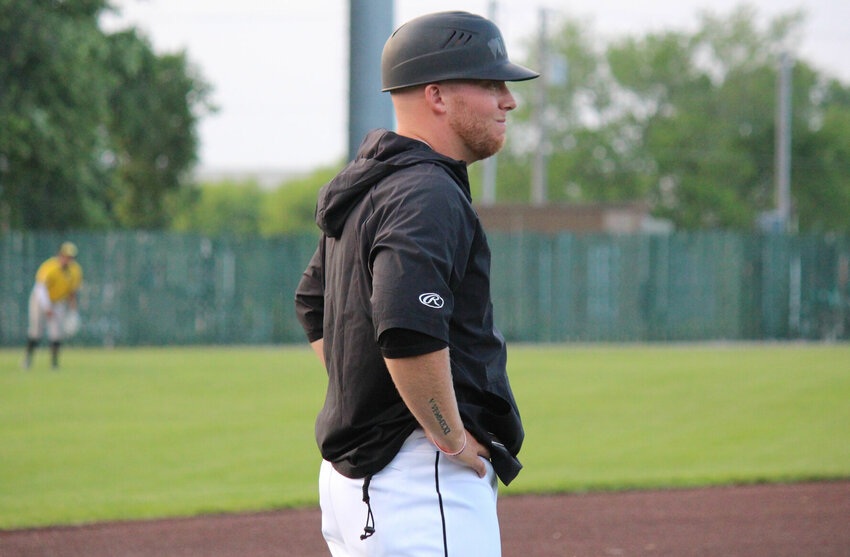 Sedalia Bombers head coach Logan Bexten watches his team from the third-base line during the season opener on May 30.   PhotoCredit: Photo by Bryan Everson | Democrat