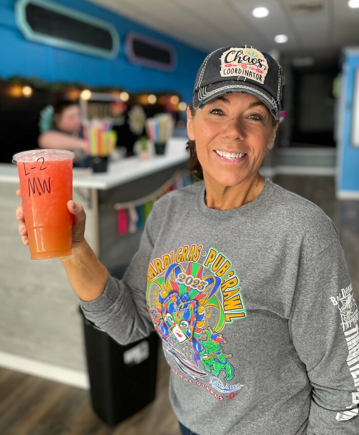 Deborah Chabino recently opened Sedalia Nutrition with her husband, Joe, at 310 S. Ohio Ave. in downtown Sedalia. Daughter Ally Adair can be seen working the bar in the background serving loaded teas and meal-replacement shakes.   Photo by Chris Howell | Democrat