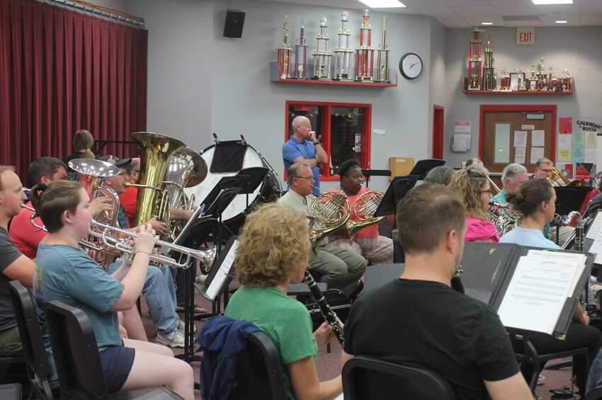Warrensburg Community Band President David Robinson, standing in the center, overlooks the ensemble's Monday, June 5 rehearsal at Warrensburg High School. Rehearsals for the summer season began last week and performances will kick off at the end of June.   Photo by Grace Fugate | Warrensburg Star-Journal