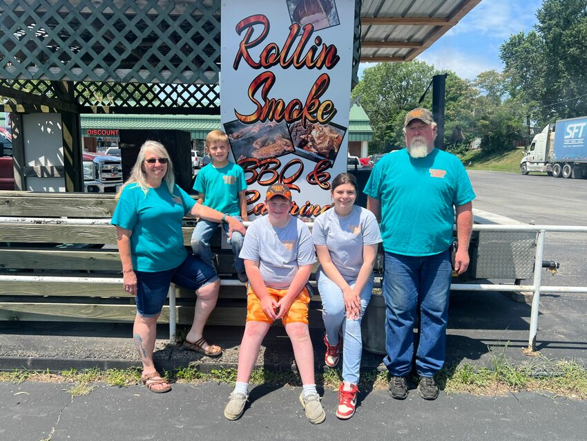 From left, Cindy Dean, Ryder Dean, Trenton Cockrum, Kiera Rudzik and Steve Riska stand in front of Rollin Smoke BBQ and Catering's new location, 1034 S. Maguire St. in Warrensburg.   Photo by Meliyah Venerable | Warrensburg Star-Journal