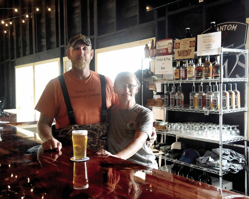 On Friday, July 7, Bryan and Leslie Welpman, owners of Welpman Springs Brewing Co. LLC, stand in their new 50-by-30-foot taproom. The couple not only offers their original beers but many local beers, liquors, and wines. The taproom is open from 1 to 7 p.m. Friday and Saturday.   Photo by Faith Bemiss | Democrat