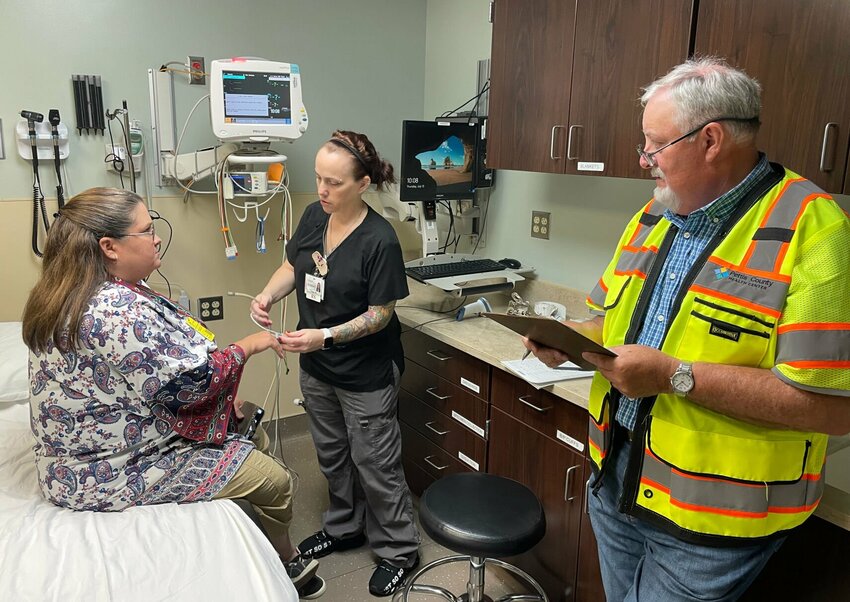 Volunteer Tiffany Klassen sought medical care Thursday, July 13 at the Bothwell Regional Health Center emergency room as part of a city-wide evacuation exercise. Christina Swank, RN, took Klassen's blood pressure as Greg Harrell observed the test.   Photo by Chris Howell | Democrat