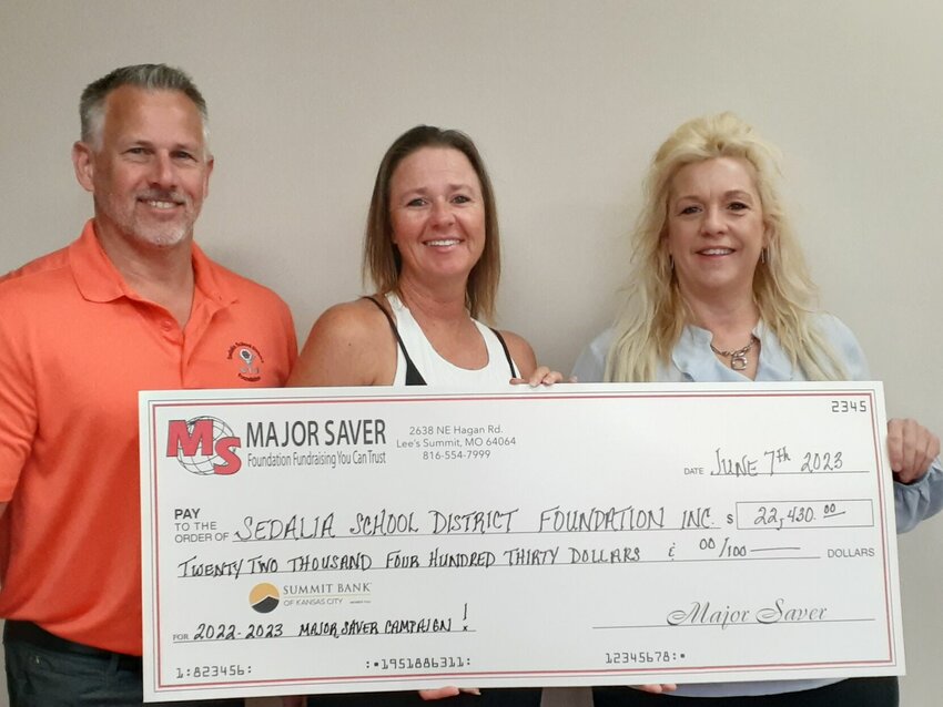From left, Sedalia School District 200 Superintendent Dr. Todd Fraley, Major Saver Holdings Operations Director Stacy Hontz, and Sedalia School District Foundation Board President Deidre Esquivel. Hontz presented the proceeds of the May 2023 Major Saver Card sales during the Foundation Board of Directors meeting in June.   Photo courtesy of Sedalia School District Foundation