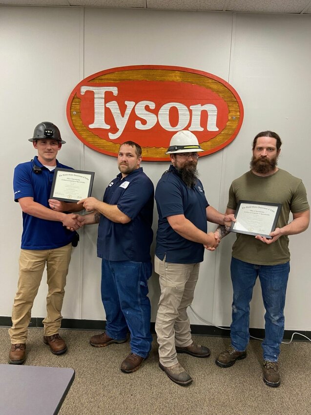 From left, Tyson Foods Supervisor Randy Winstead presents Shaun Taber his U.S. Dept. of Labor, Journeyman Certificate; Tyson Foods Supervisor David Russell presents Devon Tunis his certificate. Taber and Tunis participated in State Fair Community College&rsquo;s Apprenticeship program.   Photo courtesy of State Fair Community College