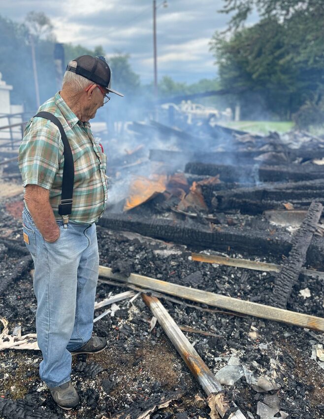 Charles Bahner, 80, looks over the ruins of St. John's Chapel in Bahner on Tuesday, Aug. 1. The 185-year-old church burned to the ground Tuesday after a probable lightning strike.   Photo by Chris Howell | Democrat