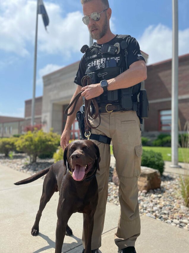 School Resource Officer Todd Asbury, a deputy with the Pettis County Sheriff&rsquo;s Office, and K9 Cezar have been assigned to the Sedalia School District 200 and will be stationed at Smith-Cotton High School. The duo is seen outside the high school on Tuesday afternoon, Aug. 22. K9 Cezar, who joined the sheriff&rsquo;s office this summer, is certified by the National Police Canine Association in explosives detection, including firearms and ammunition. &ldquo;Superintendent Todd Fraley and I have worked together in making this a reality, and our memorandum of understanding has been modified to insert this phenomenal asset in said role,&rdquo; Pettis County Sheriff Brad Anders said in a recent Facebook post. &ldquo;Again, this is a great step towards creating a safer environment for our students!&rdquo;   Photo by Chris Howell | Democrat