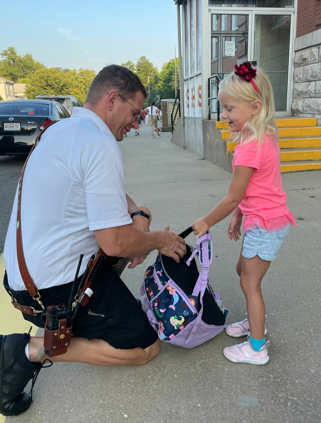Flo Hammer helps daughter Annika with her backpack Thursday, Aug. 24 for the first day of school at Sacred Heart. There are 377 children attending Sacred Heart in pre-K through 12th grade for the 2023-24 school year.   Photo by Chris Howell | Democrat