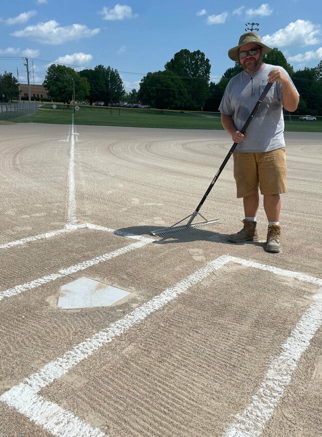 On Tuesday afternoon, Aug. 29, Sedalia Parks and Recreation employee Jeremy Bradley rakes concentric circles in the infield at Centennial Park for upcoming men's softball games. Bradley knows the players will just track-up his beautiful raking job, but says that's what it's all about.   Photo by Chris Howell | Democrat