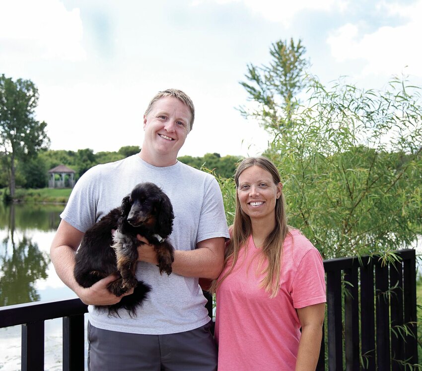 In 2022, Collin and Meghan Funkhouser, owners of Funky Bunch Pet Care LLC, hold their 14-year-old dog Kobe at Clover Dell Park. They will host the second annual Pet Loss Memorial at 8:30 a.m. Saturday, Sept. 9, at Clover Dell Lake.   File photo by Faith Bemiss | Democrat