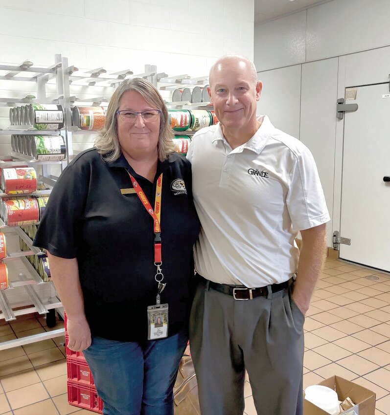 On Wednesday, Sept. 6, Debra Wenig, director of nutrition services for Sedalia School District 200, stands with John Murphy, a business development manager with Grande. Wenig is transitioning the district&rsquo;s food services from boxed meals to home-cooked. Grande is providing restaurant-grade cheese for the district&rsquo;s pizza.   Photo courtesy of Sedalia School District 200
