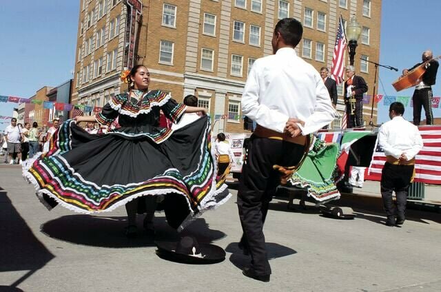 At the Hispanic Festival hosted in 2015 in downtown Sedalia, two traditional dancers perform. At the Sedalia Hispanic Festival to be hosted Saturday, Sept. 16, Central Bank will be on hand with bilingual services.   File photo by Nicole Cooke | Democrat