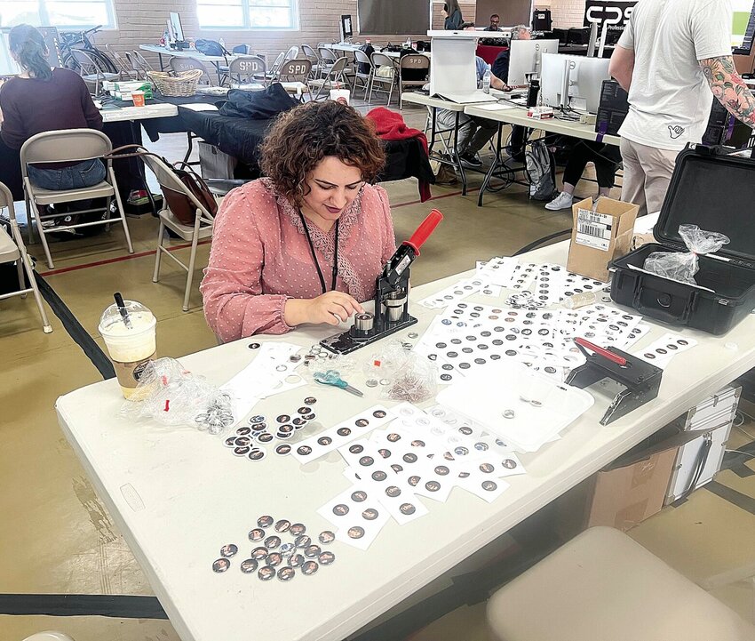 Tuesday afternoon, Sept. 26 at Convention Hall, Masrat Zahra with the University of Missouri School of Journalism creates pins for students of the Missouri Photo Workshop to take home as a souvenir.   Photo by Faith Bemiss-McKinney | Democrat