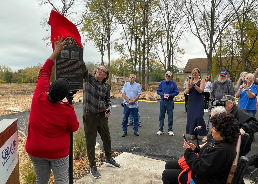 Second Ward City Councilwoman Tina Boggess and Community Development Director John Simmons unveil the historic marker for George R. Smith College on Wednesday, Oct. 25.   Photo by Chris Howell | Democrat