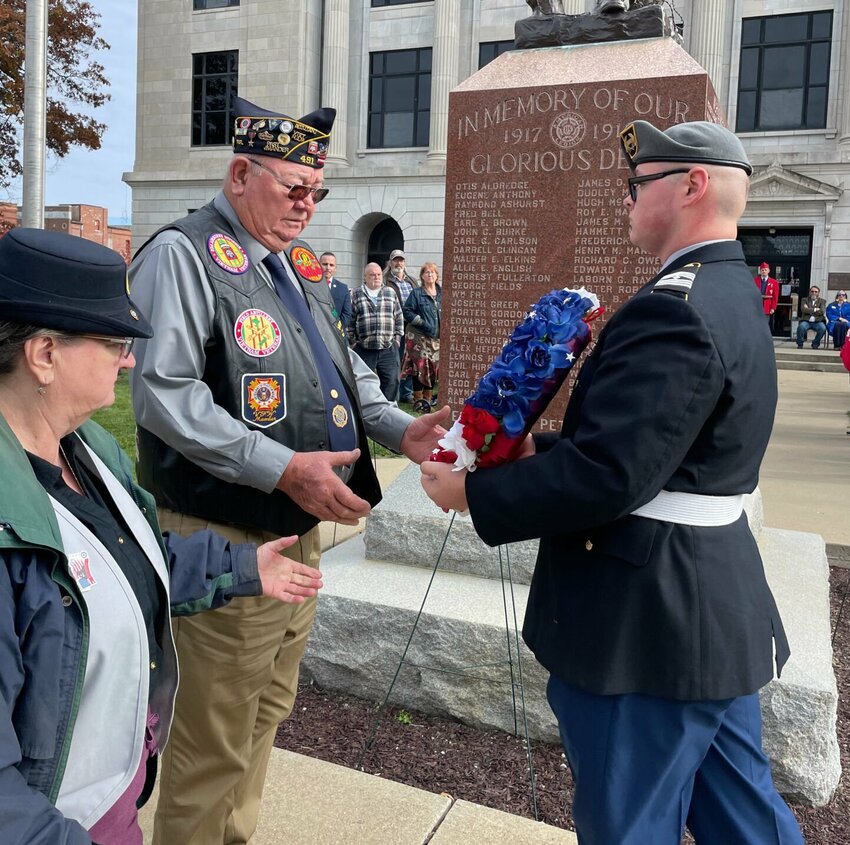 American Legion Post 520 Commander Melvin Ficken and his wife, Pat, lay a wreath for WWII soldiers from Pettis County at the base of the Doughboy statue at the Pettis Courthouse on Saturday, Nov. 11.   Photo by Chris Howell | Democrat