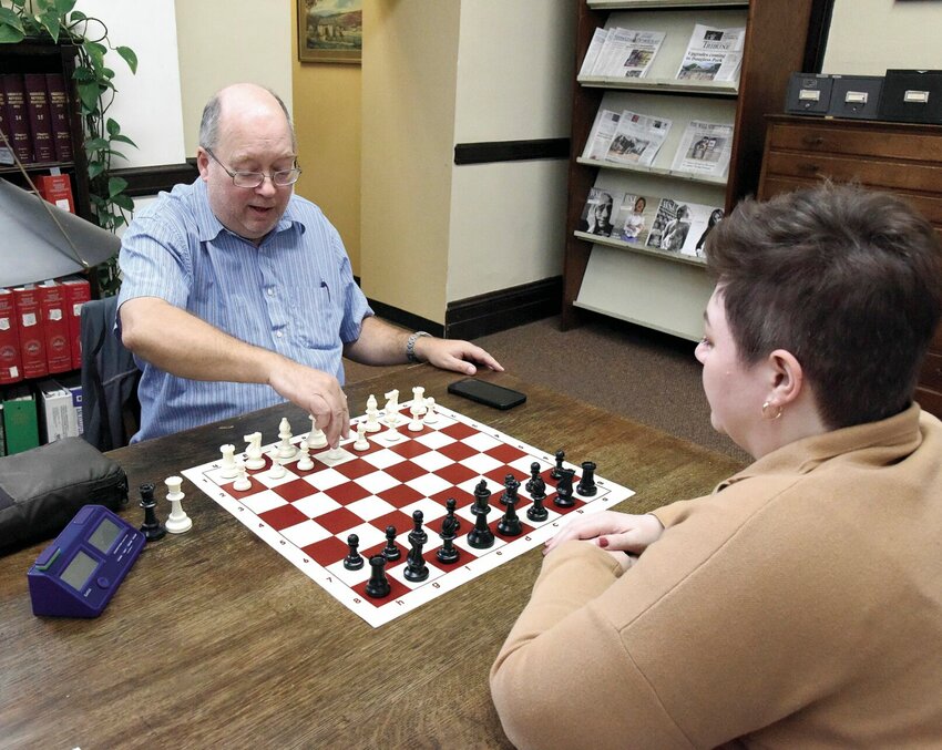On Thursday, Nov. 9, Patrick Staiert plays chess with Sarah Harper, the outreach and adult service coordinator at the Sedalia Public Library. Staiert, new to Sedalia, suggested starting a chess club, and Harper was delighted to do so. The Chess Club meets at the Public Library from 10 a.m. to noon on the third Saturday of the month.   Photo by Faith Bemiss-McKinney | Democrat